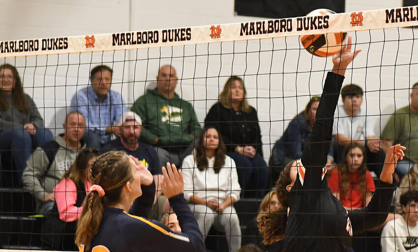 Marlboro's Jaedyn Lunsford hits the ball over the net as Highland's Bethany Childs waits at the net during Wednesday's non-league volleyball match at Marlboro High School.