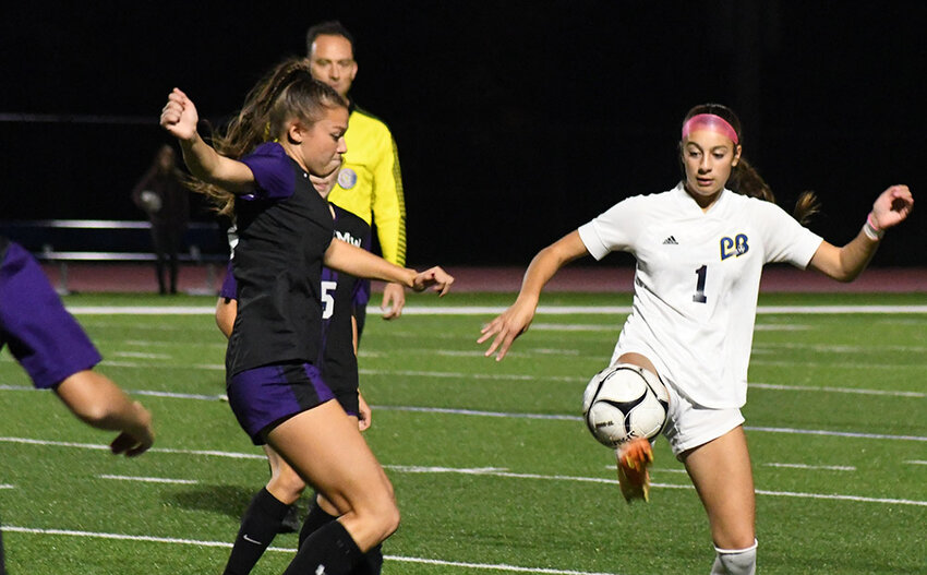Pine Bush's Ava Boffalo plays the ball as Monroe-Woodbury's Mia Menzzasalma closes in during Wednesday's Section 9 Class AAA girls' soccer game at Goshen High School.