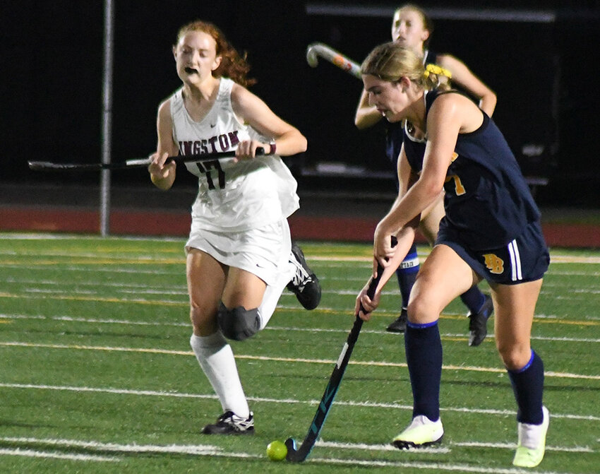 Pine Bush's Kailey Fobert brings the ball down the field as Kingston's Eleanor Fournier defends during Thursday's Section 9 Class A championship field hockey game at Taconic Hills High School.