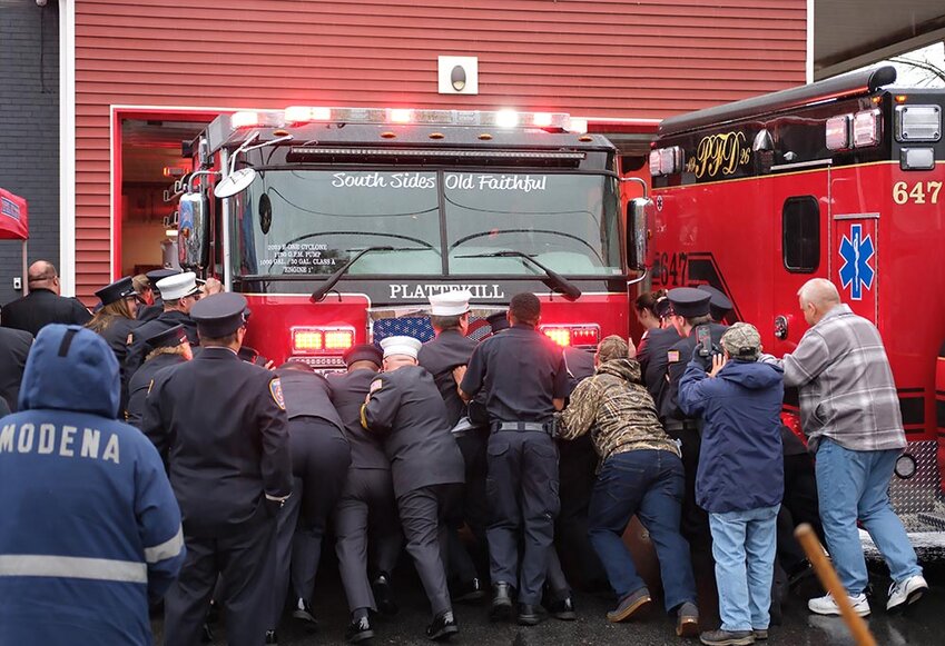 All took part in ‘pushing-in’ the new fire truck.