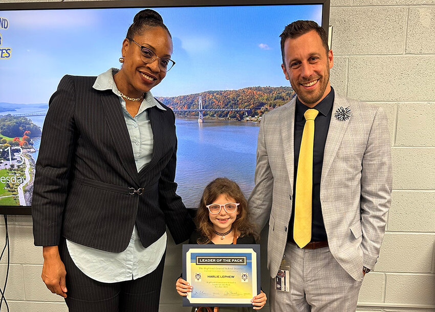 Harlie LePhew is the Highland Elementary School Leader of the Pack. She is flanked by Asst. Principal Tulani Samuel and Principal Ian M. MacCormack