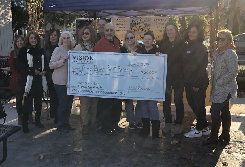 Members of Pine Bush First Fridays Inc. holding their first grant from Vision Hudson Valley, the 2023 Stuart Turner Placemaking Grant