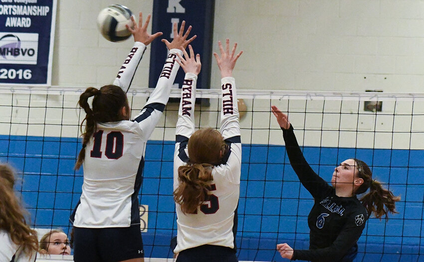 Wallkill's Kaylee DeGroat hits the ball over the net as Byram Hills' Alana Vataj (10) and Rebecca DiPietro jump to block during the NYSPHSAA Class A subregional on Nov. 7 at Wallkill High School.
