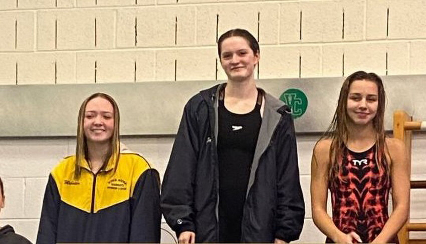 Newburgh&rsquo;s Elle Gerbes (c.) stands on the podium after winning the 50-yard freestyle at the Section 9 girls&rsquo; swimming championships on Nov. 4 at Valley Central High School. She will compete in the 50- and 100-yard freestyle events at NYS Federation championship meet on Friday and Saturday at the Webster High School Aquatic Center.