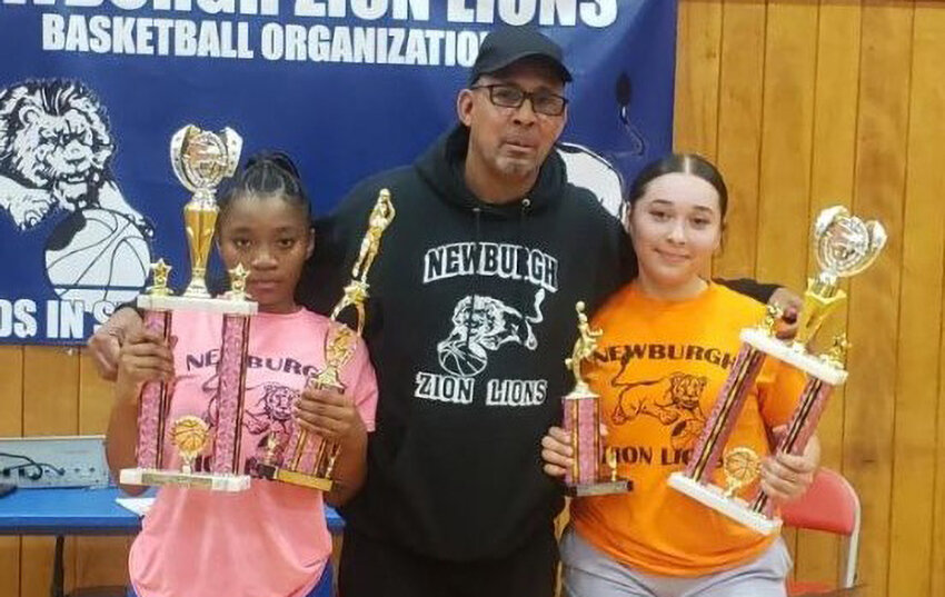 Newburgh Zion Lions Director Harold Rayford is shown with all-girls' league MVP Terri'nashje Burden, left, and Adriana Vazquez, the league's most outstanding player.
