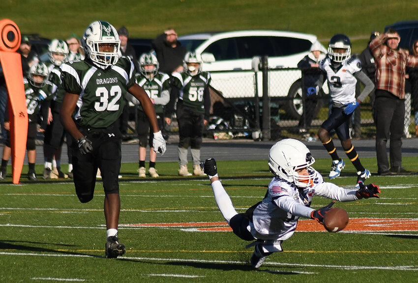 Newburgh&rsquo;s Evan Watson dives for the ball as Cornwall&rsquo;s Beya Salerno trails the play during Saturday&rsquo;s Orange County Youth Football Division 3 Super Bowl at Marlboro High School.