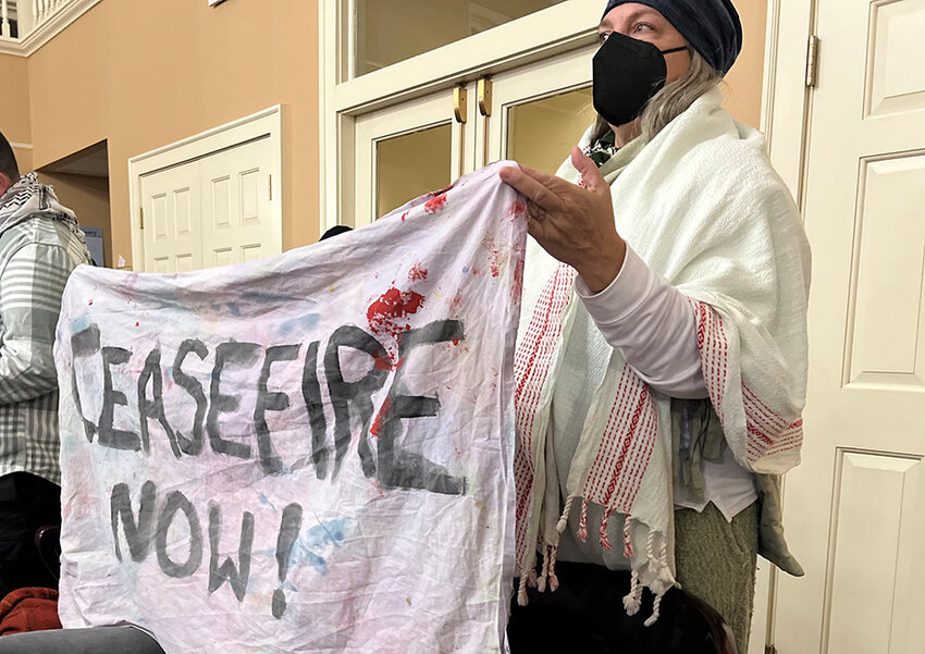 A bedsheet banner displayed at Monday&rsquo;s City Council meeting urges a more permanent ceasefire in the conflict between Israel and Hamas.
