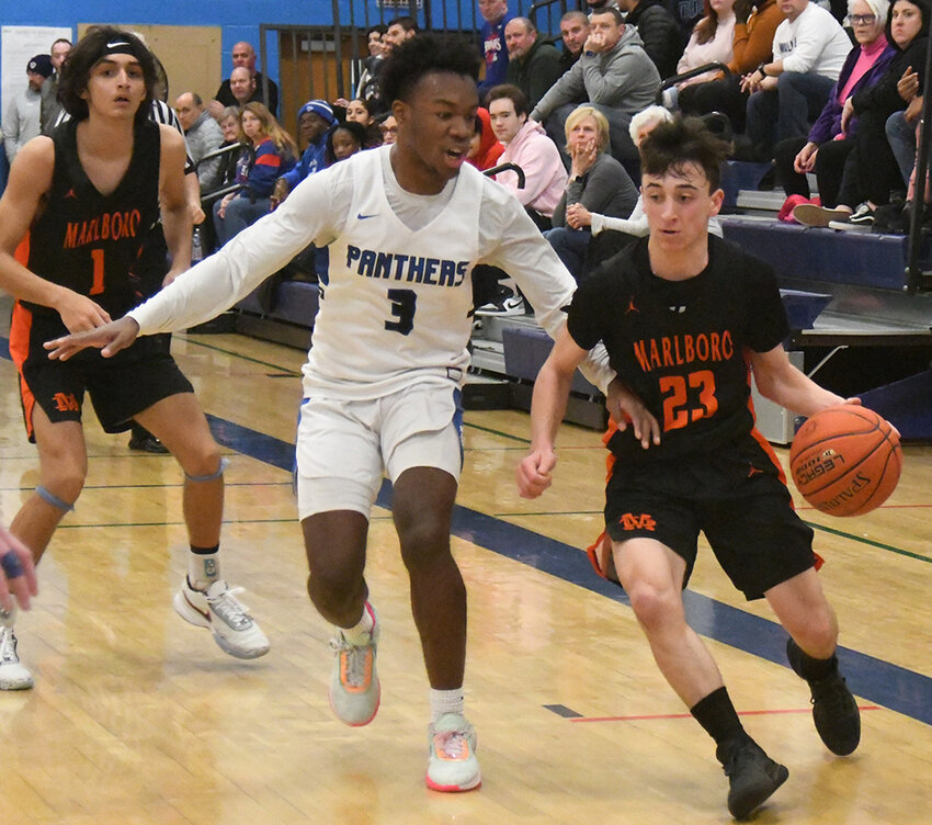 Marlboro&rsquo;s Chris DeNatale dribbles the basketball as Wallkill&rsquo;s Sean Perrin defends and Marlboro&rsquo;s Miles Brooks looks on during a MHAL boys&rsquo; basketball game on Jan. 13 at Wallkill High School.