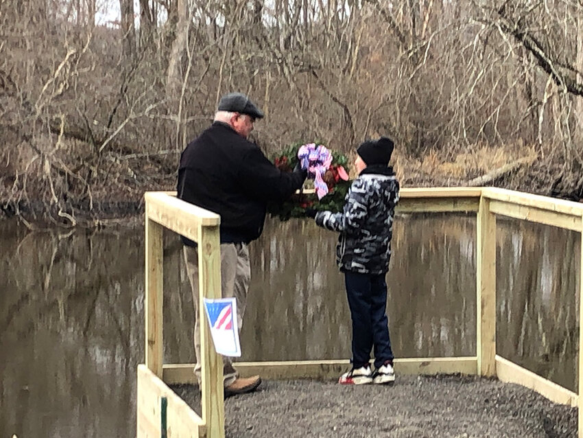 Matt Healy (left) and Sebastion (right) about to toss the wreath into Wallkill River.