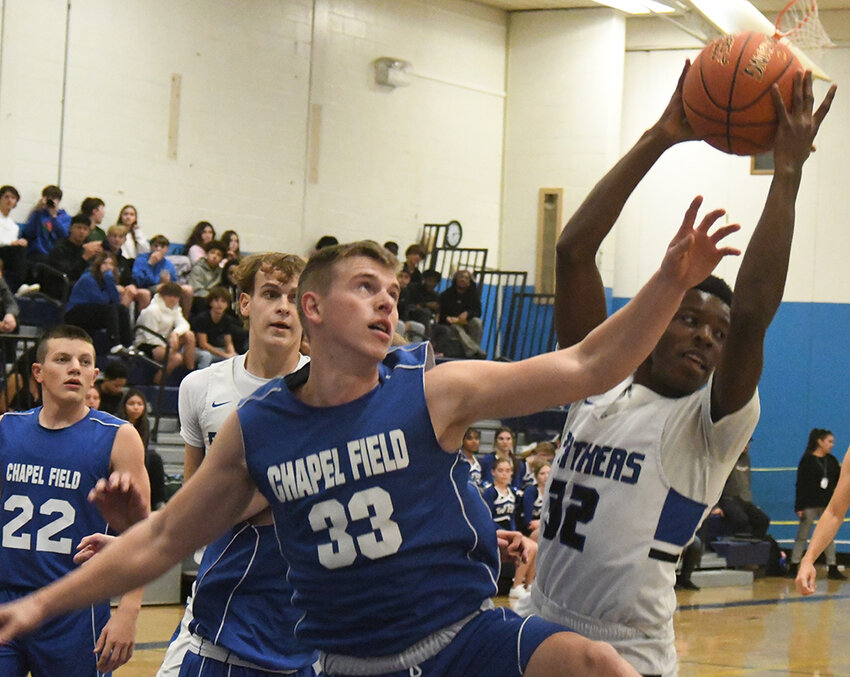 Wallkill's Isaiah Williams pulls down a rebound away from Chapel Field's Jonah McDuffie during a non-league boys' basketball game on Dec. 5 at Wallkill High School.