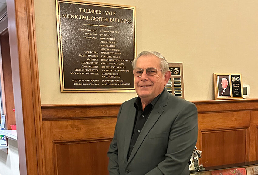 Retiring Town Of Shawangunk Supervisor John Valk stands in front of a plaque the bears his name for the Town Hall in the hamlet of Wallkill.