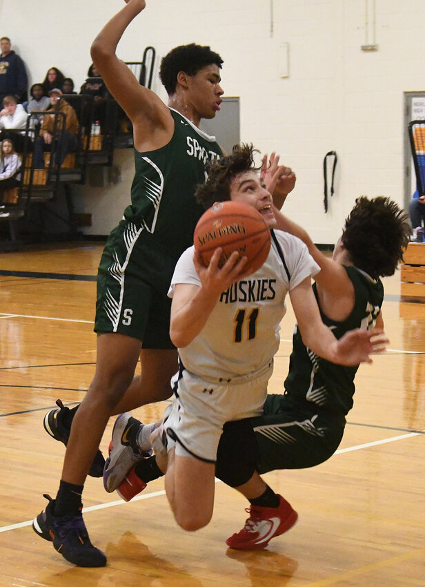 Highland&rsquo;s Reid Berean fights through the defense of Spackenkill&rsquo;s Kason Cummings and Dylan Sultzer during Friday&rsquo;s MHAL Division III boys&rsquo; basketball game at Highland High School.