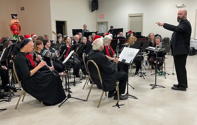 William Green, one of the co-directors/conductors of the Maybrook Wind Ensemble, leads the band in a rousing holiday concert at the Maybrook Senior Center last week. The concert featured some old favorites arranged in innovative ways as the band played to a packed house.  Green leads the band with fellow director/conductor William Gillespie.