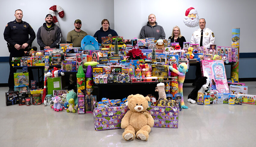 The Lloyd Police gathered Toys for local kids this year. Pictured [L-R] Lt. Phil Roloson, Brandon Parker, Steve Delmar, Christine LaForge, Frank Piscopo, Leslie Benson and Chief James Janso.
