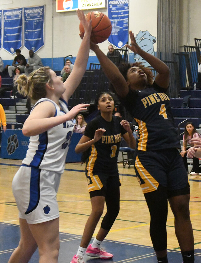 Pine Bush&rsquo;s Jah-esa Stokes goes up for a shot as Wallkill&rsquo;s Sam Dembinsky defends and Pine Bush&rsquo;s Leticia Johnson looks on during Saturday&rsquo;s Wallkill Coaches vs. Cancer championship girls&rsquo; basketball game at Wallkill High School.