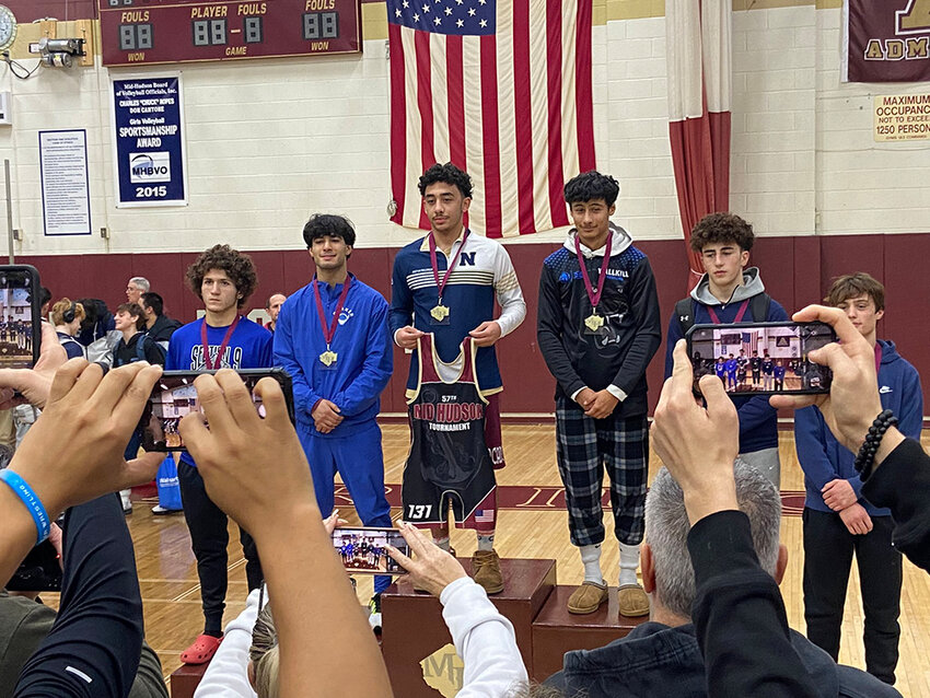 Newburgh&rsquo;s Matthew Mercado stands on the podium after winning the 131-pound championship at the Mid Hudson Tournament on Thursday at Arlington High School.