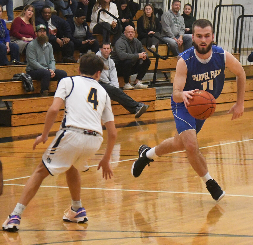 Chapel Field&rsquo;s Mikey Bonagura drives the basketball as Highland&rsquo;s Michael Koehler defends during Wednesday&rsquo;s non-league boys&rsquo; basketball game at Highland High School.