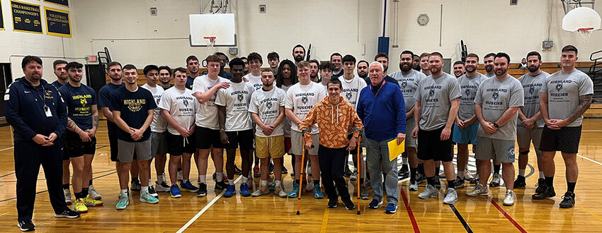 Highland manager Andrew Lovgren, who suffers from cerebral palsy, is shown in front of the Highland boys&rsquo; basketball team after receiving their shirts with Lovgren&rsquo;s catchphrase, &ldquo;Focus, play smart.&rdquo;