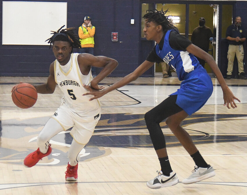 Newburgh&rsquo;s Elnathan Johnson drives past Middletown&rsquo;s Rahman Alexander during Friday&rsquo;s OCIAA Division I boys&rsquo; basketball game at Newburgh Free Academy.