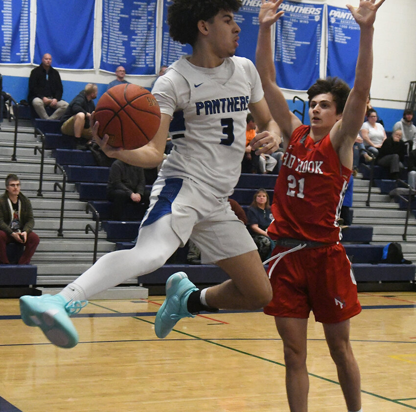 Wallkill&rsquo;s Miles McKenney saves the ball from going out of bounds as Red Hook&rsquo;s Colby Benassutti defends during Friday&rsquo;s MHAL boys&rsquo; basketball game at Wallkill High School.