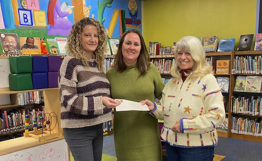 Friends president Joanne Zambito, presents a check to Marlboro Library Director Christina Jennerich. Also pictured: Friends volunteer Emily Amoia.