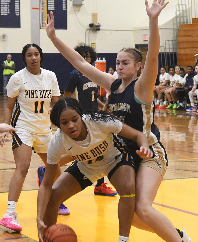 Pine Bush&rsquo;s Ketura Rutty makes a move in the paint as Newburgh&rsquo;s Lindsay Dando defends and Pine Bush&rsquo;s Amaya Segarra (11) and Newburgh&rsquo;s Noelle Roberts (2) look on during Thursday&rsquo;s OCIAA Division I girls&rsquo; basketball game at Pine Bush High School.