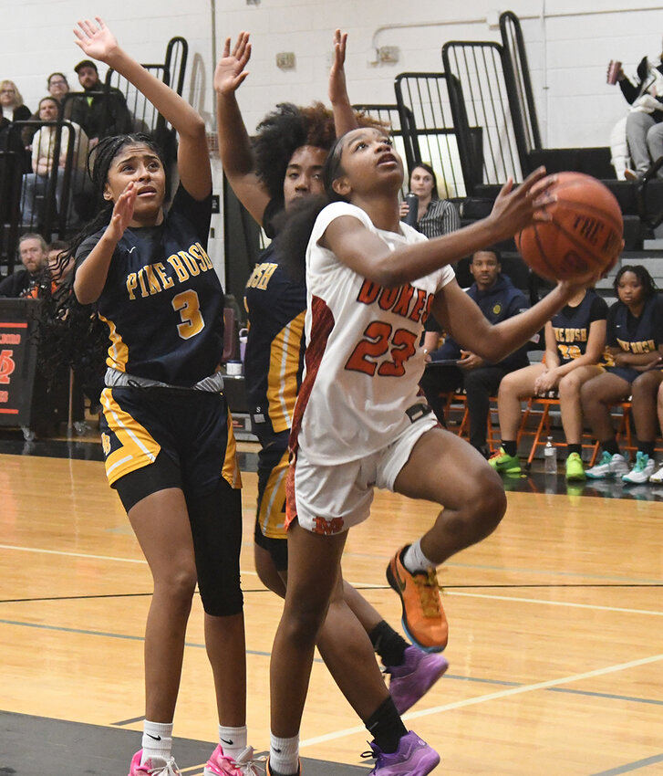Marlboro’s Nalyah Campbell goes up for a shot as Pine Bush’s Leticia Watson (3) and Jah-esa Stokes defend during Wednesday’s non-league girls’ basketball game at Marlboro High School.