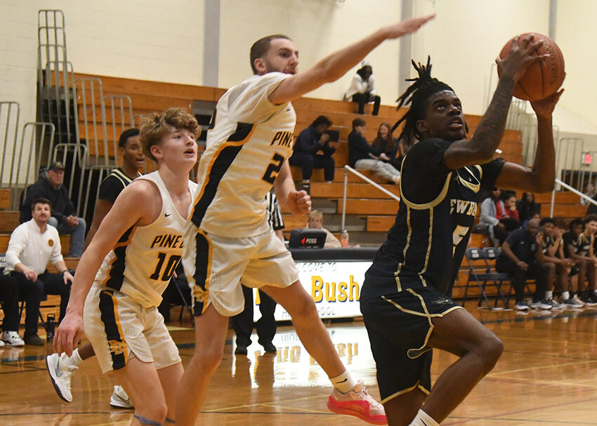 Newburgh’s James Thorpe shoots over Pine Bush’s Nathan Fontana during Wednesday’s OCIAA Division I boys’ basketball game at Pine Bush High School.