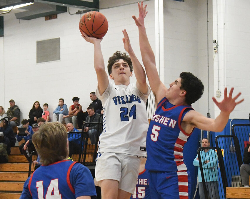 Valley Central’s Alex Miller shoots as Goshen’s Jake Giordano defends and Seamus Smith (14) and Jaiden Chan defend during Saturday’s OCIAA Division II boys’ basketball game at Valley Central High School in Montgomery.