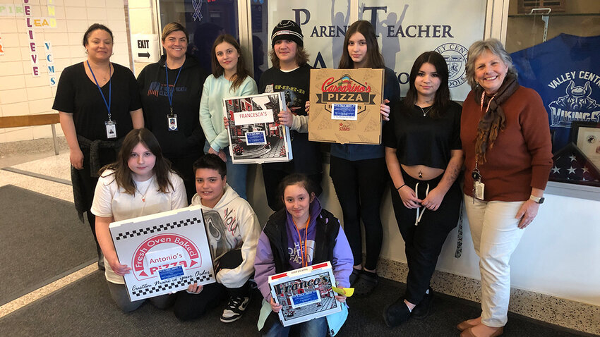 Students and advisors of SADD holding pizza boxes with the sticker shocks.