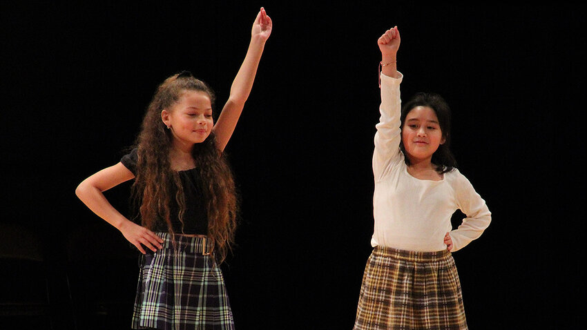 (l-r) Fourth graders Mia Zuehlke and Valene Bersig perform to One Direction’s hit “What Makes You Beautiful”.
