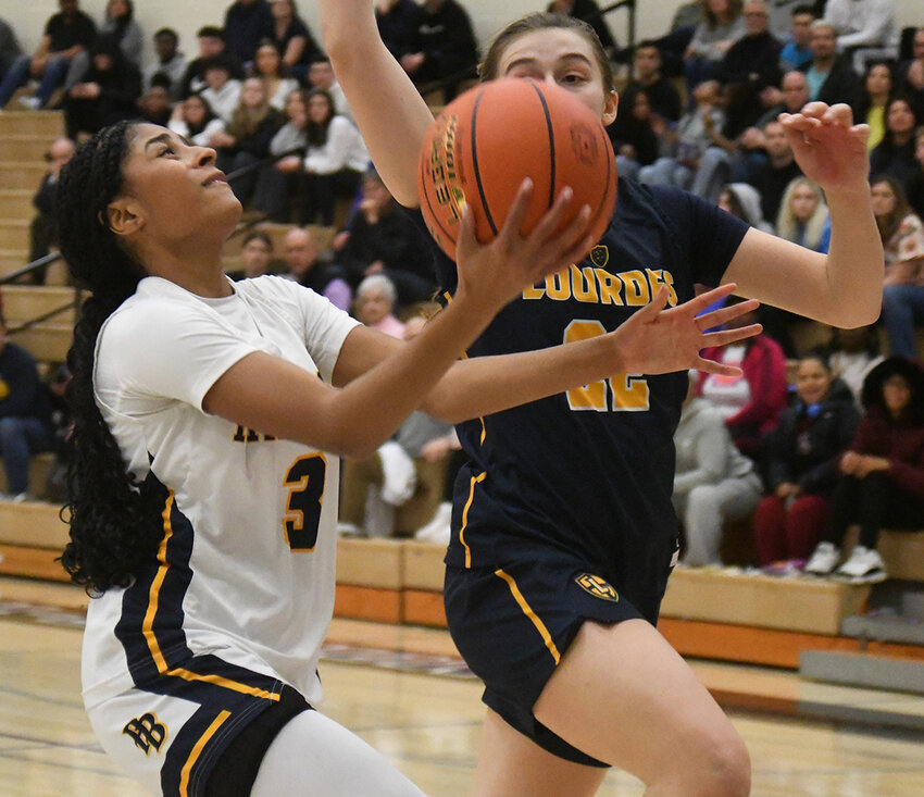 Pine Bush&rsquo;s Leticia Watson goes up for a shot as Our Lady of Lourdes&rsquo; Simone Pelish defends during Saturday&rsquo;s Section 9 Class AAA championship girls&rsquo; basketball game at Monroe-Woodbury High School in Central Valley.