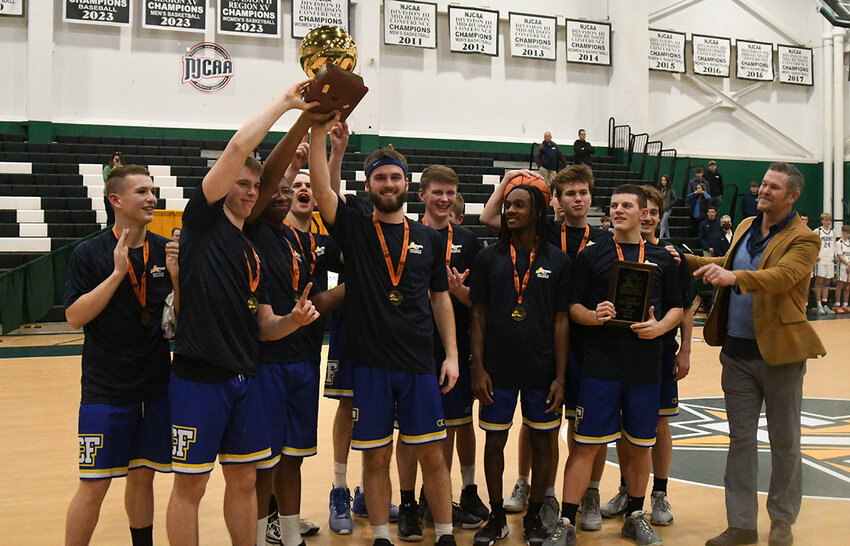 The Chapel Field Lions hold up the Section 9 Class D trophy and plaque after winning the championship with a 54-42 win over Mount Academy on Feb. 27 at SUNY Sullivan.