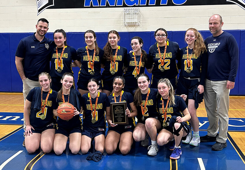 The Highland girls’ basketball team poses with the Section 9 Class B championship plaque on Thursday at Mount St. Mary College.