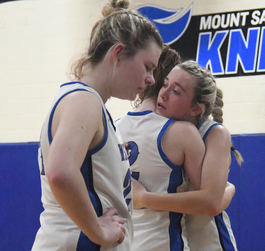 Wallkill’s Aoife Brady embraces Alex Dembinsky as Samantha Dembinsky stands next to them after Friday’s NYSPHSAA Class AA girls’ basketball regional final at Mount St. Mary College in Newburgh.