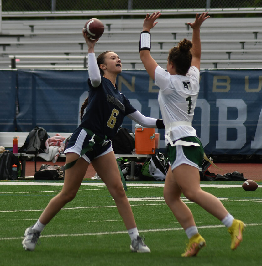 Newburgh&rsquo;s Megan Evans throws the football as Minisink Valley&rsquo;s Kate O&rsquo;Neill rushes during a flag football game on May 6, 2023, at Academy Field in Newburgh.