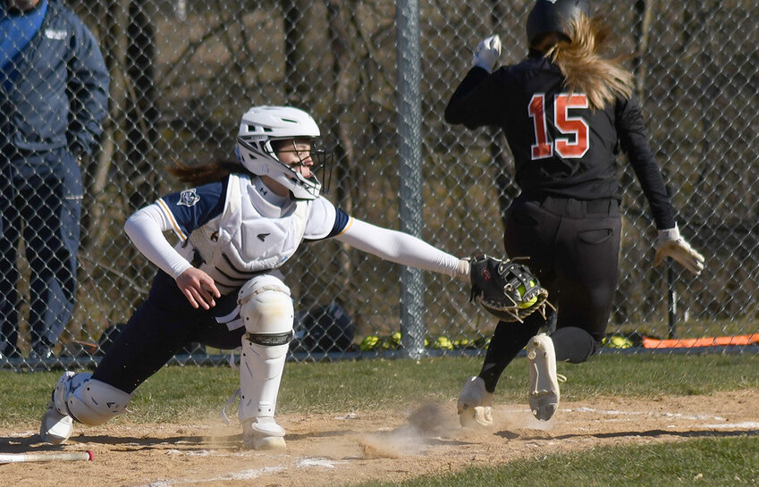Highland catcher Delaney Reid tries to tag Marlboro&rsquo;s Emma Jackson at home plate during a non-league softball game on March 30, 2023, at Highland High School.