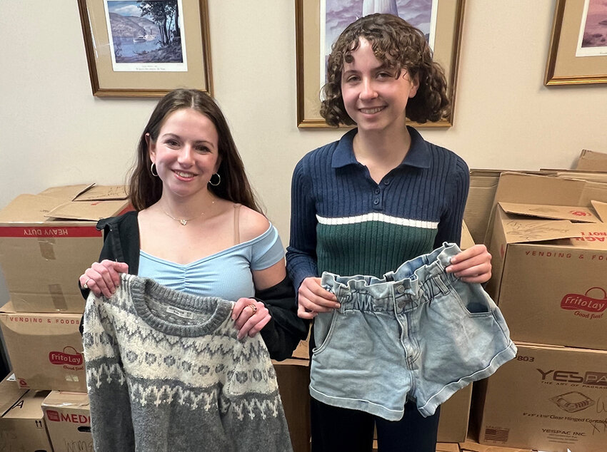 Highland High School students Rachel Branda (left) and Rylie Klein executed a successful clothing giveaway event in February, as part of their civic readiness capstone project for their Citizenship in Action class.