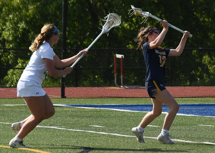 Highland’s Kelcey Whalen prepares to shoot as Wallkill’s Brianna Merrill defends from behind during a non-league girls’ lacrosse game on May 18, 2023, at Wallkill High School.