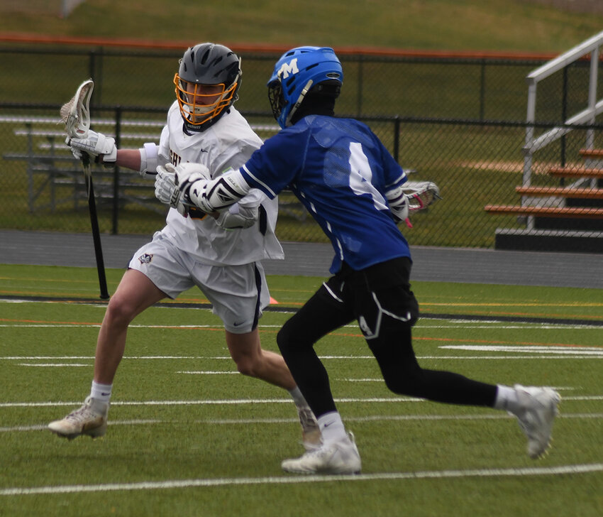 Highland&rsquo;s Trevor Coates carries the ball as Middletown&rsquo;s Camron Headley defends during Thursday&rsquo;s non-league boys&rsquo; lacrosse game at Marlboro High School.