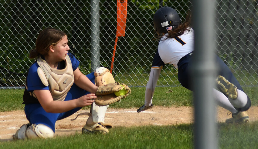 Wallkill catcher Kasey Garzione looks to tag Highland&rsquo;s Katie Dauenheimer as she tries to score during a non-league softball game on May 9, 2023, at Highland High School.