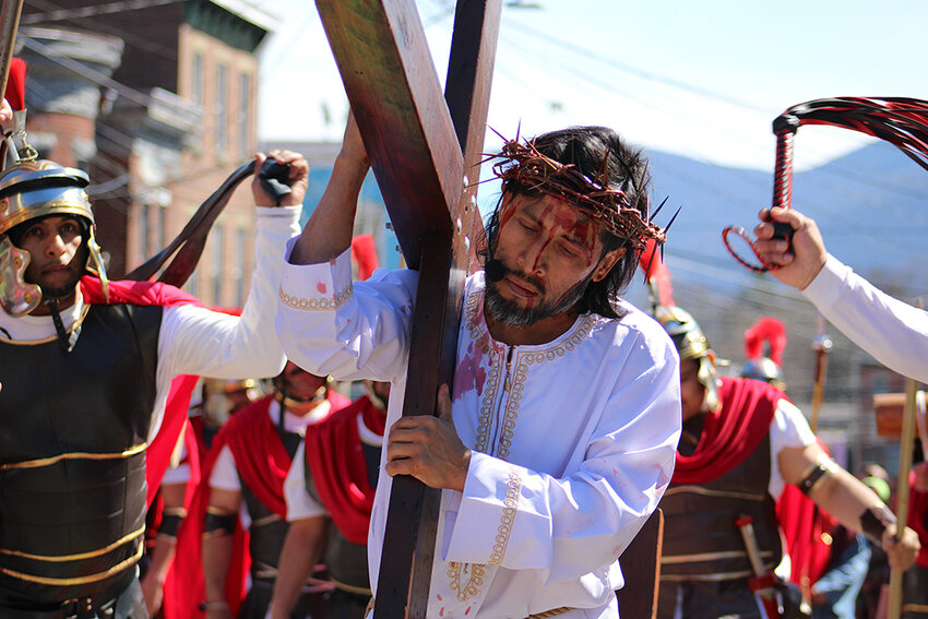 Even while walking with his cross, Jesus is struck and beaten by the soldiers.