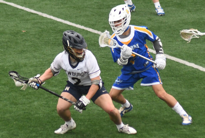 Newburgh&rsquo;s Niko Bucholz tries to move the ball as Washingtonville&rsquo;s Luke Lombardi defends during a non-league boys&rsquo; lacrosse game on April 2 at Academy Field in Newburgh.