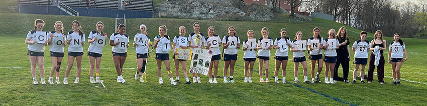The Highland Huskies pose after honoring senior captain Caitlin Becker for her 100th draw control after a non-league girls’ lacrosse game on April 9 at Highland Middle School.
