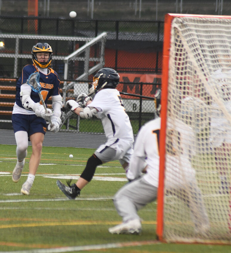 Pine Bush&rsquo;s Gavin Carey shoots the ball as Highland&rsquo;s Andrew Terranova defends and goalkeeper Landon Zehr waits for the ball during Thursday&rsquo;s non-league boys&rsquo; lacrosse game at Marlboro High School.