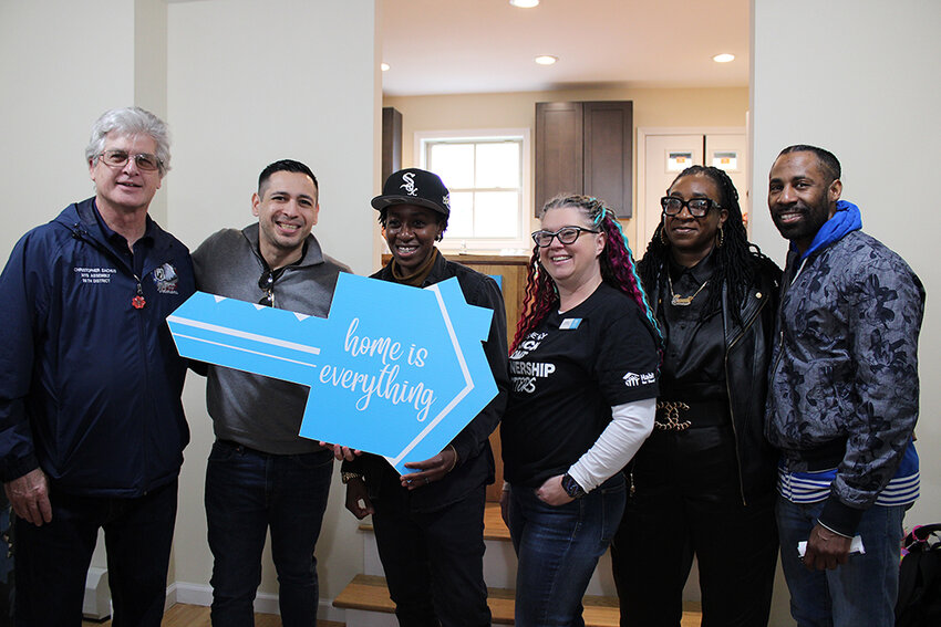 New homeowner Shyniece (third from left) is joined by family, friends, Habitat advocates and local elected officials to celebrate the completion her new home.