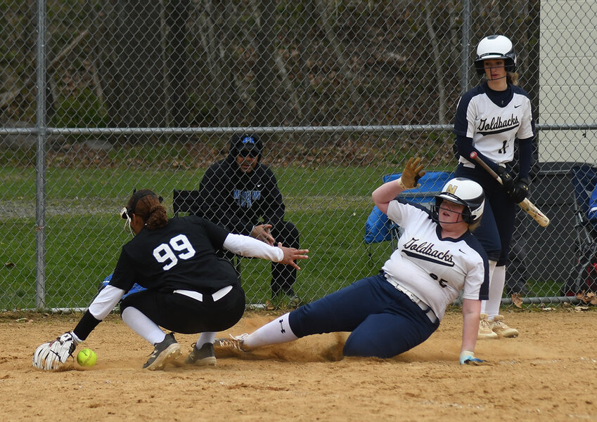 Newburgh&rsquo;s Taryn Judson slides into home plate as Middletown pitcher Bethany French takes the throw during Sunday&rsquo;s Minisink Valley tournament softball game at Minisink Valley Middle School in Slate Hill.