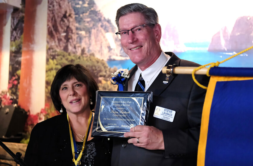 Rotarian Christine Giangrasso presented Steve Laubach with a plaque to honor his 40 years as a member.