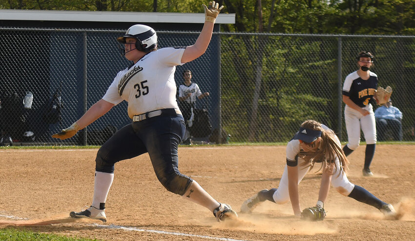 Newburgh&rsquo;s Taryn Judson avoids a tag by Pine Bush first baseman Emma Boffalo during Friday&rsquo;s OCIAA Division I softball game at Pine Bush Elementary School.