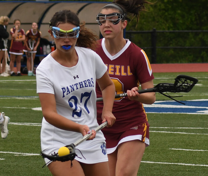 Wallkill’s Marysa Collins scoops a ground ball as James I. O’Neill’s Victoria Evangelista defends.